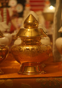 Tibetan Treasure Vase - Auspicious Gold Symbol Prosperity Vase glowing on Pema Osel Ling shrine